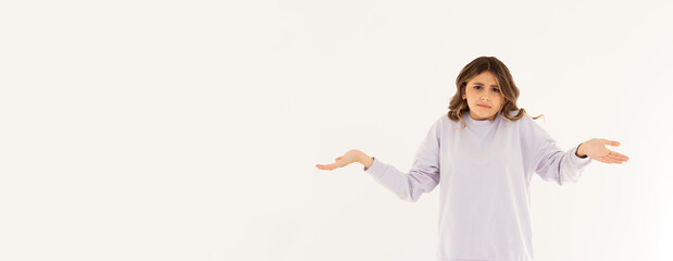 Confused thoughtful confused young woman holding copy space on palm over white background