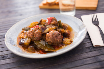Steamed meatballs with stewed vegetables on plate