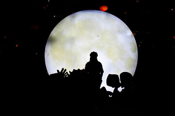 Silhouette shadow of traveler thai women people portrait posing for take photo with full moon and lighting star background outdoor in Furong Zhen and Tujia ancient town at Yongshun city in Hunan China