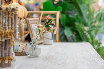 The background of the park decoration has a corner table and wooden chairs for sitting and relaxing during the day. Amidst the various flowers, the beauty of the green grass.