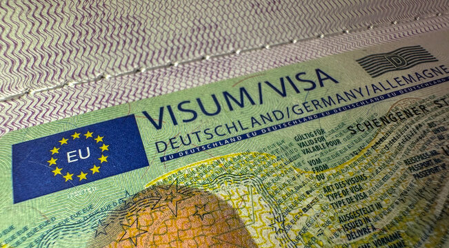 Close up detail of Germany visa fixed to passport EU Schengen
