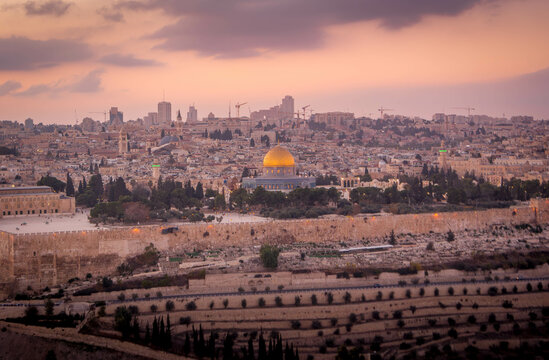 The panorama scenic view over the Dome of Rock Muslim temple and the Al-Aqsa mosque, the Muslim shrines, on the Temple Mount in the Old City of Jerusalem, during the sunset in Israel.
