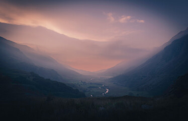 Ogwen valley Wales UK at twilight - serene landscape with misty mountains, tranquil river, and dramatic sunset, scenic nature, peaceful countryside, atmospheric and picturesque evening”