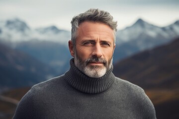 Fototapeta premium Portrait of a blissful man in his 50s wearing a classic turtleneck sweater over backdrop of mountain peaks