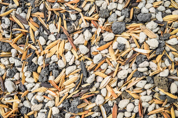 A spread of rice husks during the process of making rice husk charcoal to be used as a growing medium.