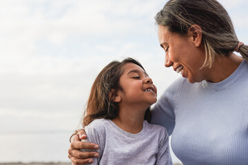 Happy latin mother and little daughter having fun together outdoor - Family love and mom day concept
