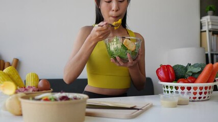 Woman enjoys fresh salad in slow motion, surrounded by colorful vegetables. Emphasize healthy eating habits and wellness lifestyle in a kitchen setting. Perfect for nutrition-based content