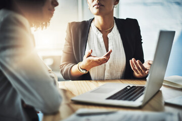 Meeting, hands and laptop in office for management, discussion and planning at table. Businesswomen, technology and idea in workplace with strategy, brainstorming and partnership in company at desk