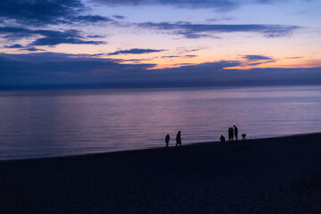 silhouette of a family walking on the beach