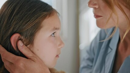 Tender mother touching daughter hair at home closeup. Woman kissing toddler