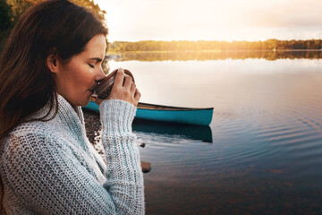 Outdoor, lake and coffee to enjoy for woman, nature and sunrise in morning, water and break for vacation. Travel, holiday and girl with tea, drink and trip in autumn with peace in Australia.