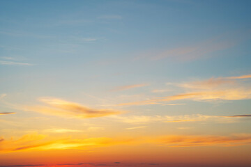 Fototapeta premium summer evening, sunset in yellow, orange and pink with clouds, background