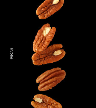 Creative layout made of pecan nuts on the black background. Food concept. Macro concept.