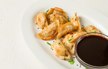 japanese fried gyoza dumplings, with pork, sesame seeds, green onions,