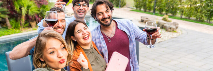 Happy friends taking selfie with red wine in hand – young people having fun in outside drinking red wine - horizontal web banner size for header