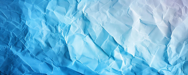Obraz premium Light blue crumpled paper texture background displaying the intricate folds and creases of the material,