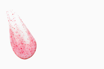 A smear of pink cream on a light background