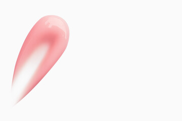 A smear of pink cream on a light background