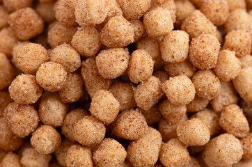 A Background of Mini Ball Shaped Cinnamon Toast Flavored Breakfast Cereal