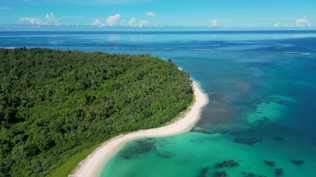 Drone shot of the coast of Sipora Island. Sunny morning, holiday destination, palm trees, beach, ocean. Turquoise water. Mentawai Islands, Indonesia, Sumatra, Asia, 4K.