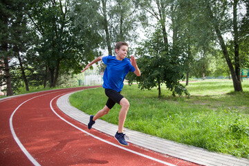 An athlete runs along a stadium bend.
