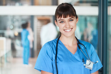 Fototapeta premium Portrait, happy woman and proud nurse in clinic for healthcare services, career and medicine. Face, medical professional or confident female surgeon with smile at wellness hospital ready for nursing