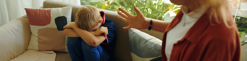 Header with mother talking seriously with her child at home