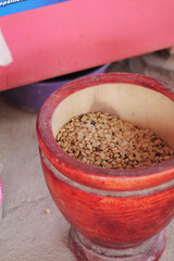 Farmers use wooden mortars and pestles to break the husks apart from the coffee beans to remove unwanted husks from coffee beans before processing them to produce high quality coffee beans for export.