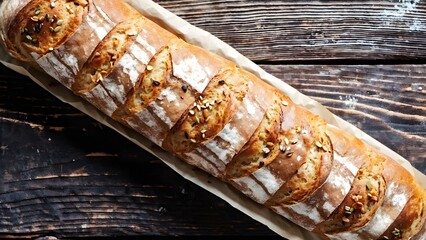 single long freshly baked bread on a rusty wooden table