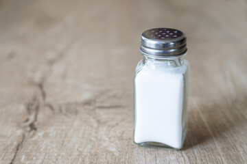 Glass salt shaker on the table.