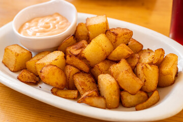 patatas bravas (spicy potatoes) A ​​traditional snack in Spain consisting of baked or boiled potatoes dipped in sauce, Spanish Cuisine
