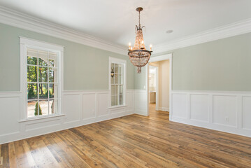 Bright Dining Room with Double Doors, Chandelier, and Natural Light Coming In
