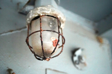 Lamp with rust in old military war submarine warship ship interior.close up.