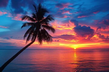 Obraz premium Tropical Sunset Over Ocean with Palm Tree