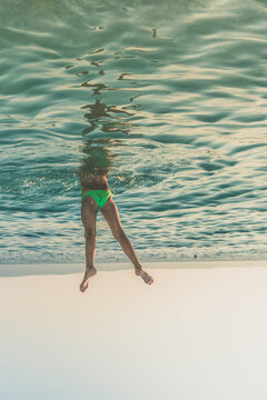 handstand under water and two legs over sea surface