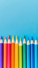 Row of multi-colored pencils on a pink, blue, red and yellow backgrounds