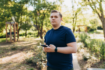 Young 30s man smiling confident using smartphone at street. Communication and gadgets, connection concept. Man holding on cell smartphone while relaxing outdoors, Urban lifestyle banner