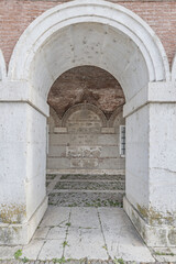 Obraz premium Stone arches of an old building with the portico of an interior courtyard