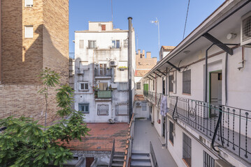 Fototapeta premium Inner courtyard of the block with access to individual homes and stairs with metal balustrades