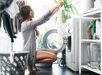 Woman, check clothes and washing machine for cleaning in home, hygiene and loading laundry in appliance. Female person, shirt and housework tasks on morning, cotton and routine of dryer on floor