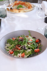 Fresh Salad with Cheese and Olives on Table