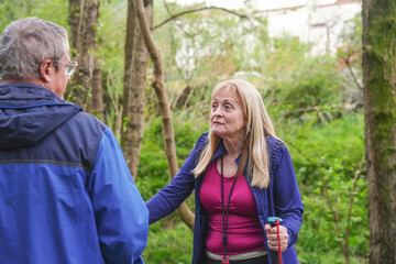 Adult wife angry with her husband walking on a path