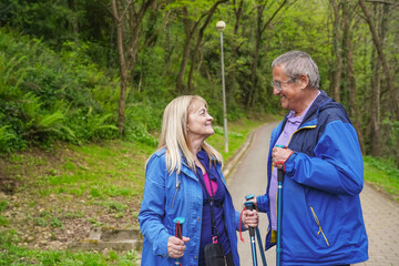 happy elderly couple walking through nature. Sport in old age