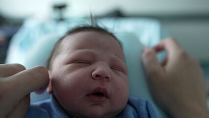 Newborn baby sleeping peacefully, mother's hand caressing infant serene and content expression emphasizes the essence of tranquility and warmth in early infancy-1.jpegNewborn baby sleeping peacefully,