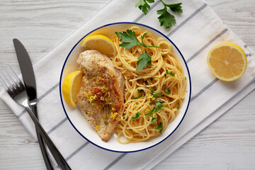 Homemade Lemon Pepper Chicken with Spaghetti Pasta on a Plate, top view.