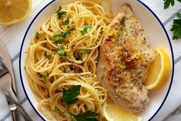 Homemade Lemon Pepper Chicken with Spaghetti Pasta on a Plate, top view.
