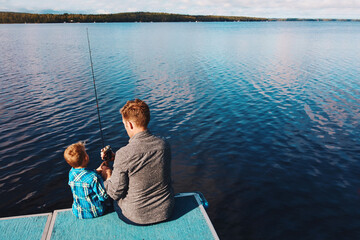 Fototapeta premium Back, child and fishing with man in summer at lake for vacation, together and relax in morning. Family, father and boy in nature by water for holiday, learning or gear for outdoor adventure with dad