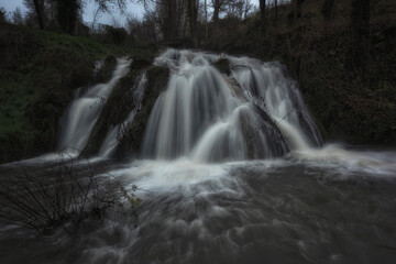front view of the Tubilla del Agua waterfall in Burgos on a cold winter day