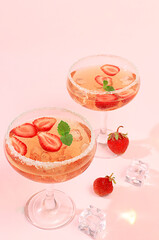 Modern still life with pink martini, alcoholic cocktail, strawberries on elegant modern background, minimal concept for bar and holiday party, cafe, advertising banner, selective focus,