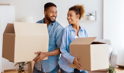 Relocation. African American Spouses Carrying Moving Boxes Smiling Each Other Standing Back-To-Back Indoor